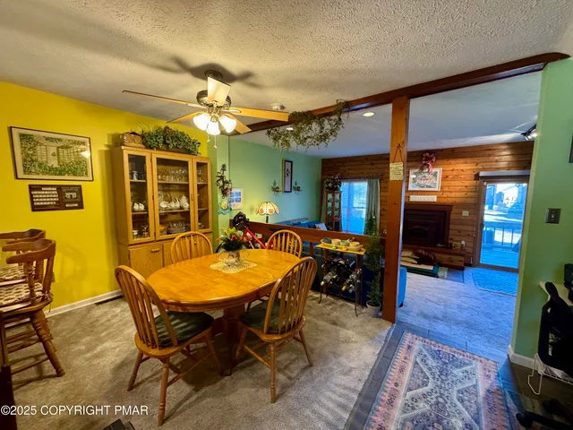 a dining room with a wooden table and chairs