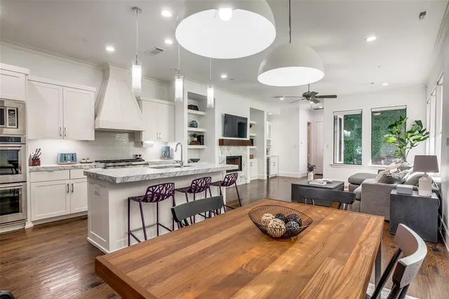 a kitchen with kitchen island granite countertop a sink and wooden floor