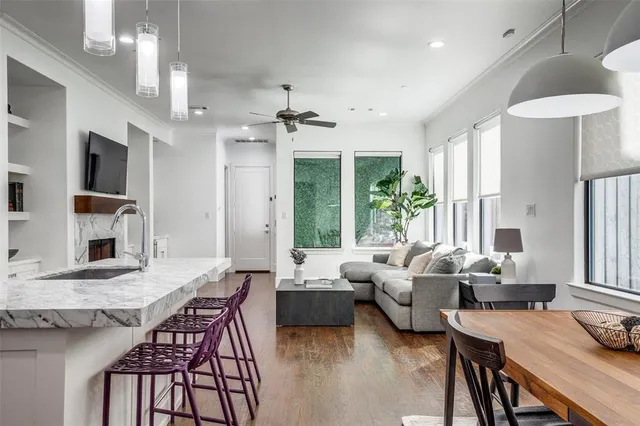 a living room with fireplace furniture and a large window