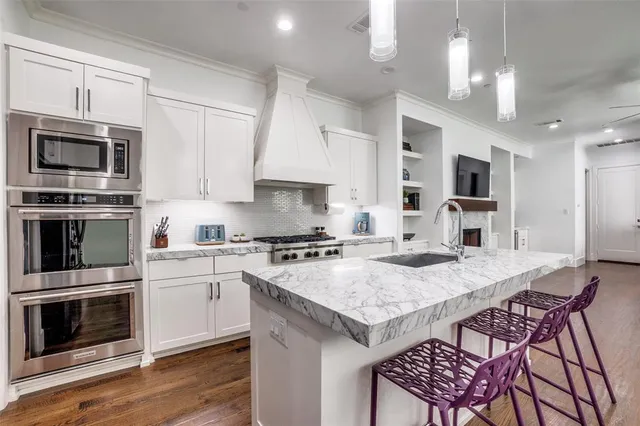a kitchen with a stove a microwave and wooden cabinets