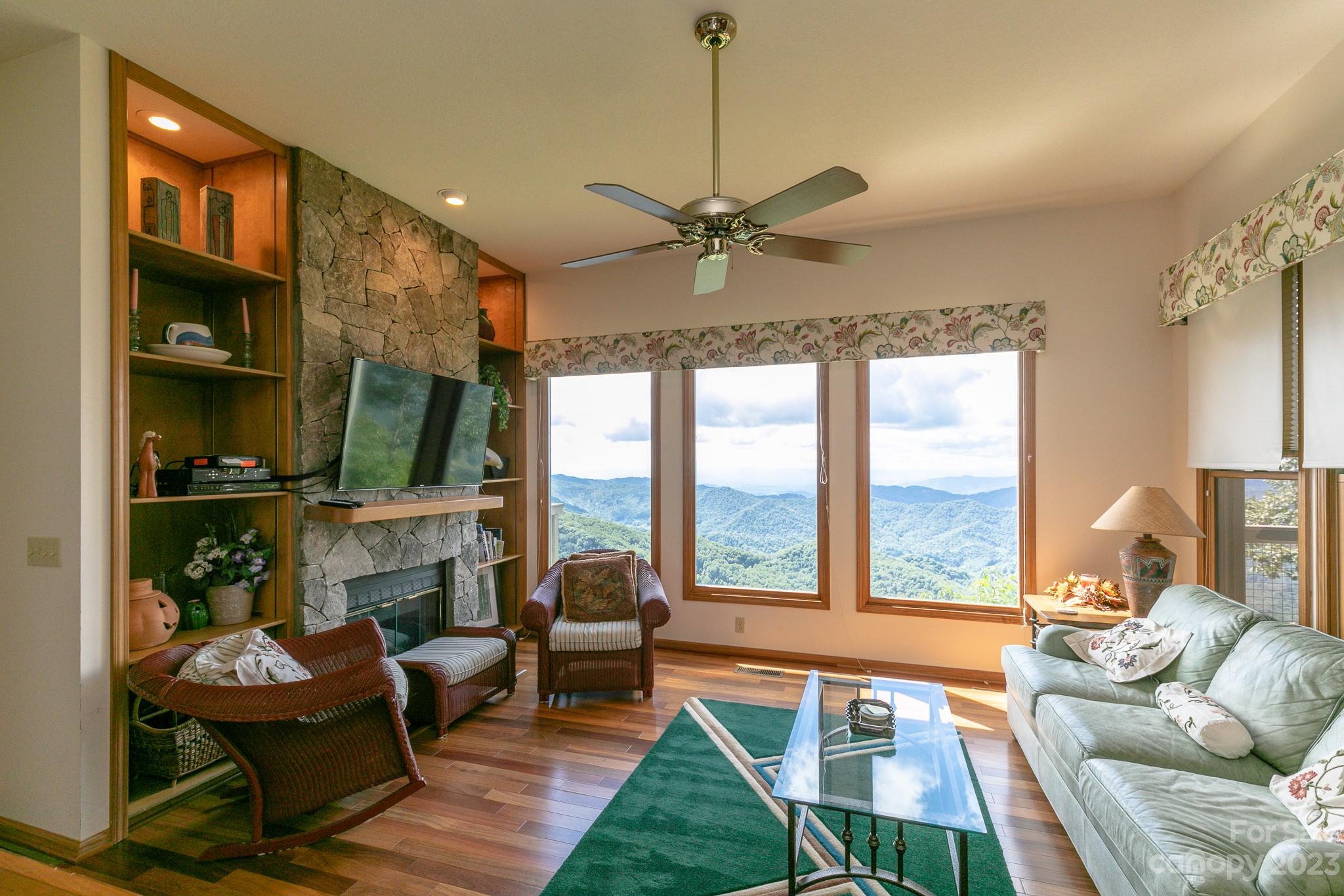 a living room with furniture a large window and a table