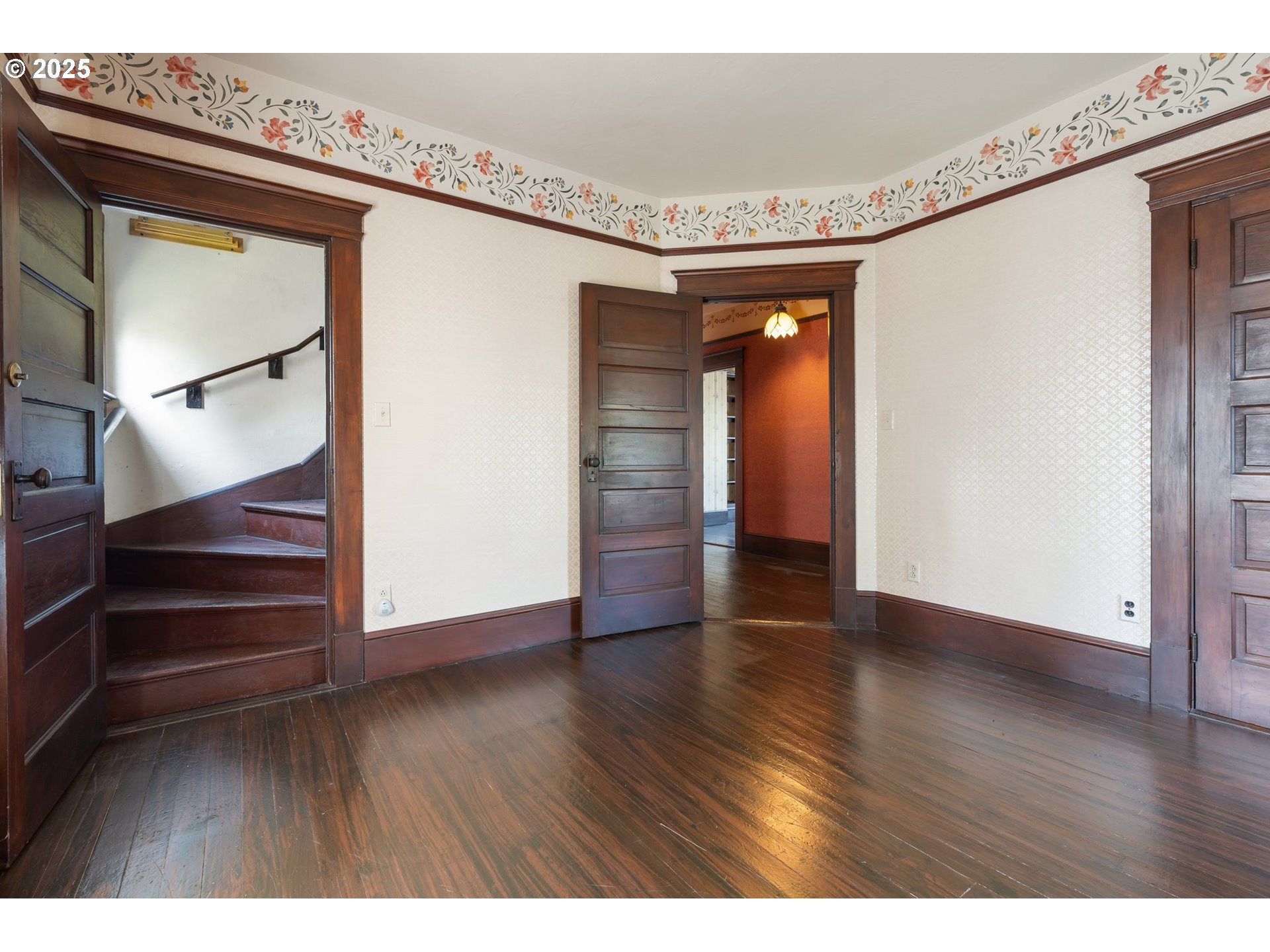 1110 D Street Vader, WA 98593 - Photo 25 of 45 a view of an empty room with wooden floor and stairs