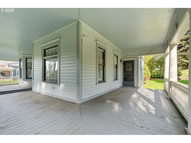 a front view of a house with a tree