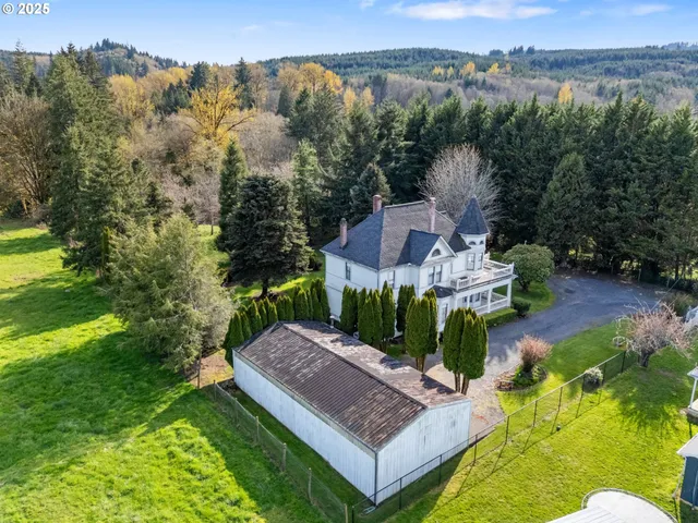 an aerial view of a house with garden space and street view