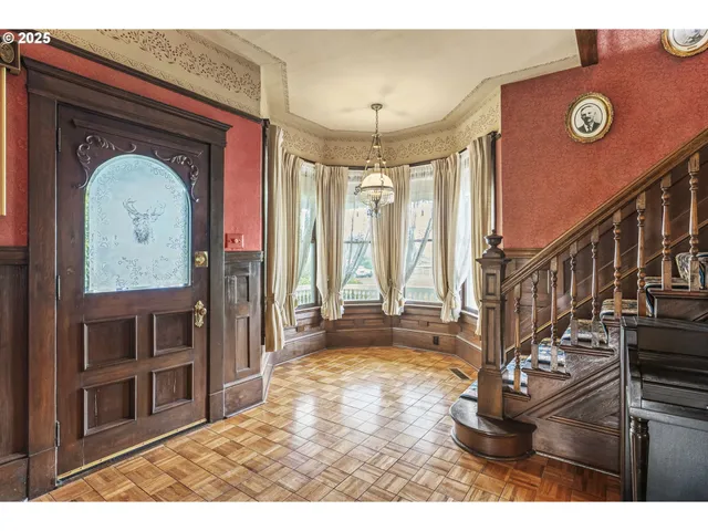 a view of an entryway with wooden floor