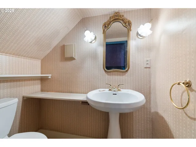 a bathroom with a sink a toilet and mirror