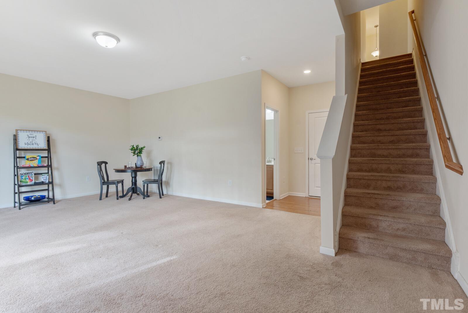 637 Edgewater Ridge Court Apex, NC 27523 - Photo 25 of 31 a view of an empty room with stairs and furniture