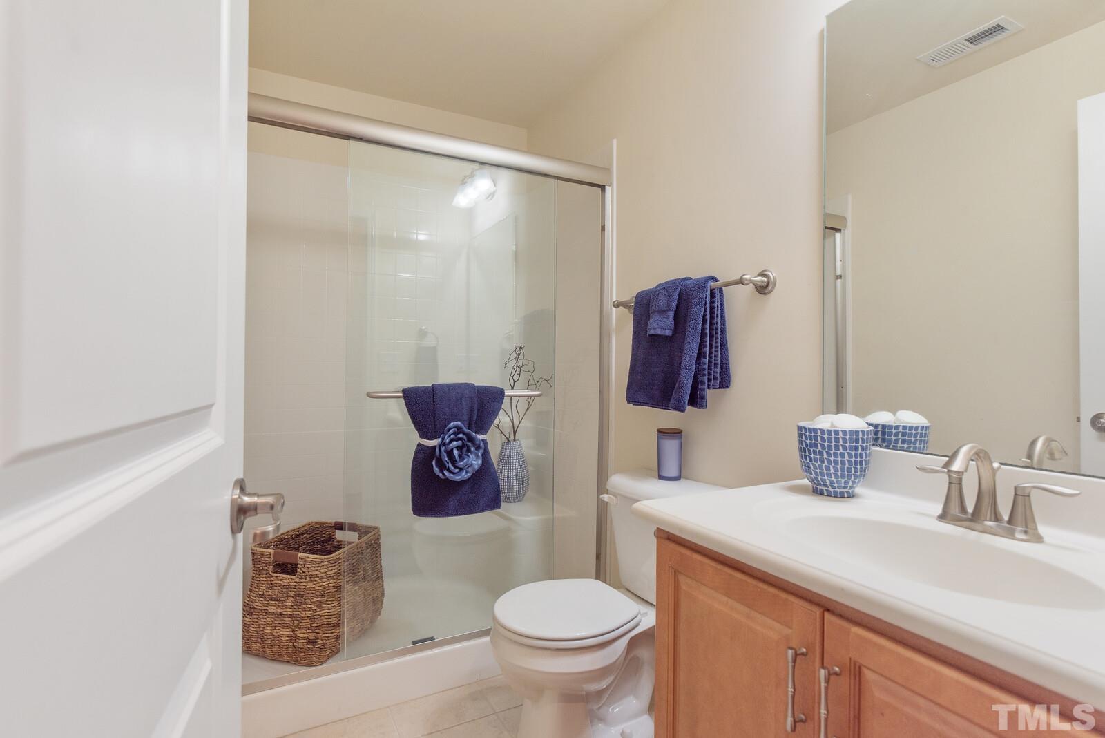 637 Edgewater Ridge Court Apex, NC 27523 - Photo 29 of 31 a bathroom with a toilet sink and mirror