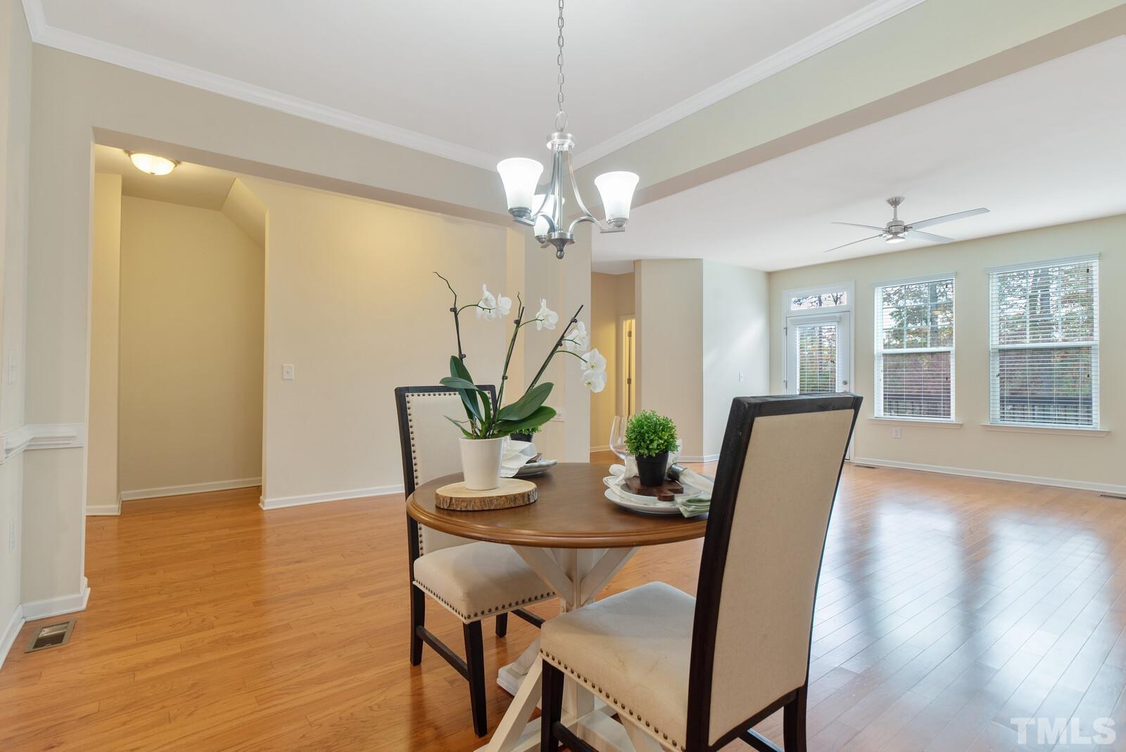 637 Edgewater Ridge Court Apex, NC 27523 - Photo 8 of 31 a view of a dining room with furniture and wooden floor