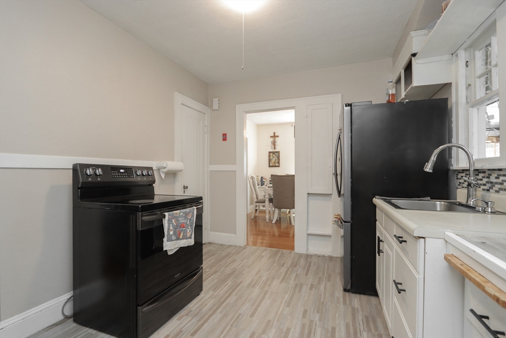 34 Preston Street Springfield, MA 01109 - Photo 13 of 34 a kitchen with stainless steel appliances granite countertop a refrigerator stove and sink
