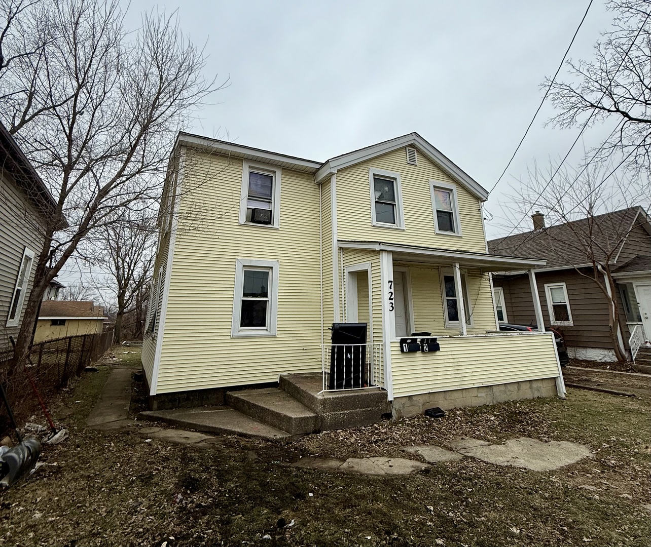 723 Richards Street, Unit 2 Joliet, IL 60433 - Photo 2 of 13 a view of a white house with a large windows