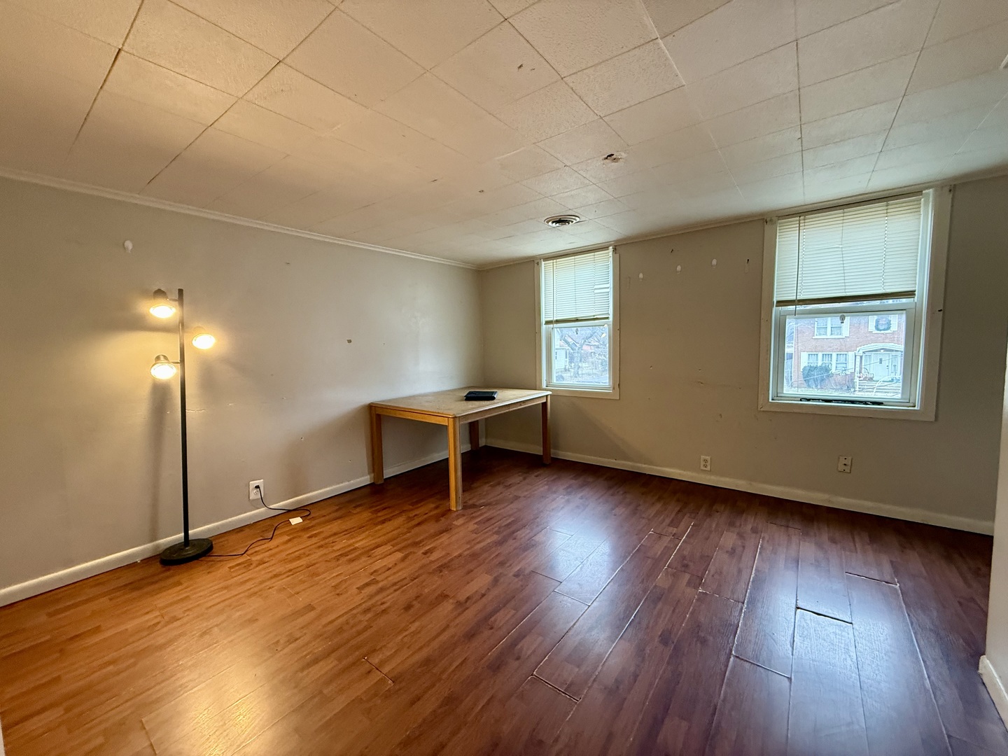 723 Richards Street, Unit 2 Joliet, IL 60433 - Photo 3 of 13 a view of an empty room with wooden floor and a window