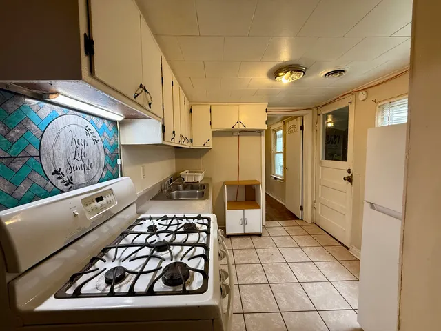 a kitchen with stainless steel appliances granite countertop a stove and a refrigerator