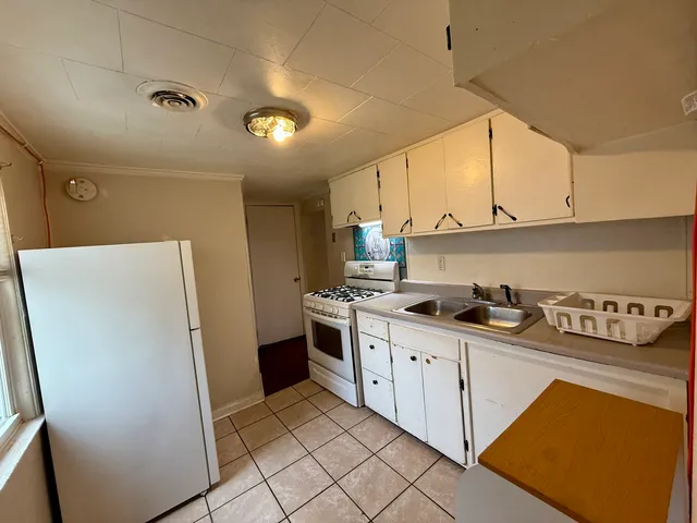 a kitchen with stainless steel appliances a refrigerator sink and cabinets