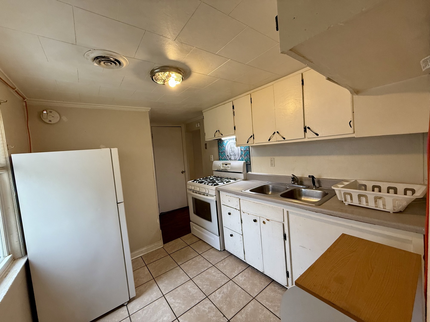 723 Richards Street, Unit 2 Joliet, IL 60433 - Photo 7 of 13 a kitchen with stainless steel appliances a refrigerator sink and cabinets