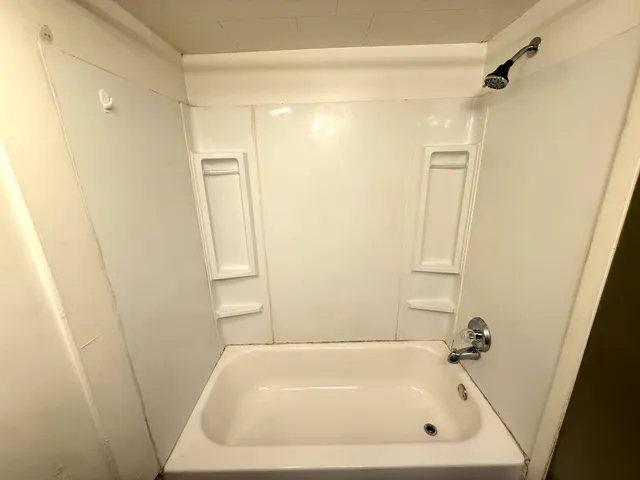a bathroom with a tub and shower