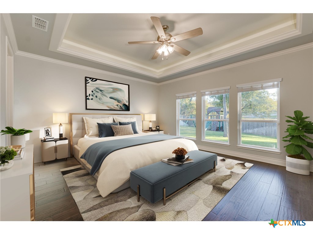 1729 Las Lomas Court Temple, TX 76502 - Photo 12 of 43 Primary bedroom retreat with tray ceiling and hardwood floors (virtually staged)