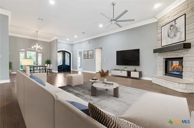 a living room with furniture and wooden floor