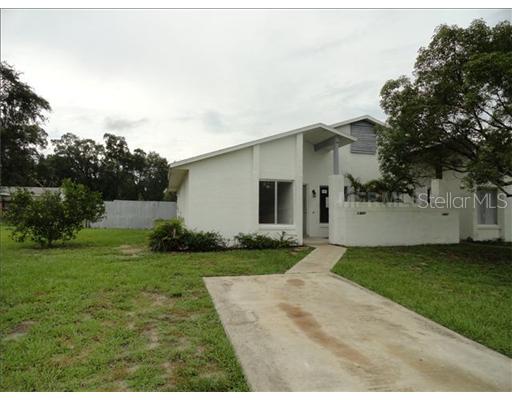10425 Riva Ridge Trail Orlando, FL 32817 - Photo 1 of 1 a view of a white house next to a yard with big trees
