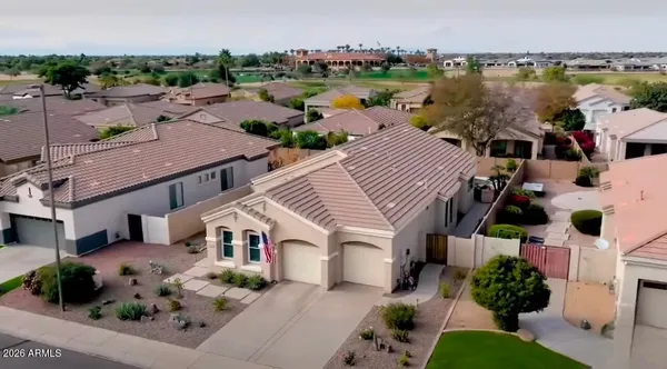 an aerial view of house with yard and ocean view
