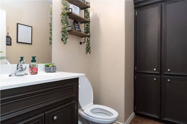 a bathroom with a sink vanity and toilet