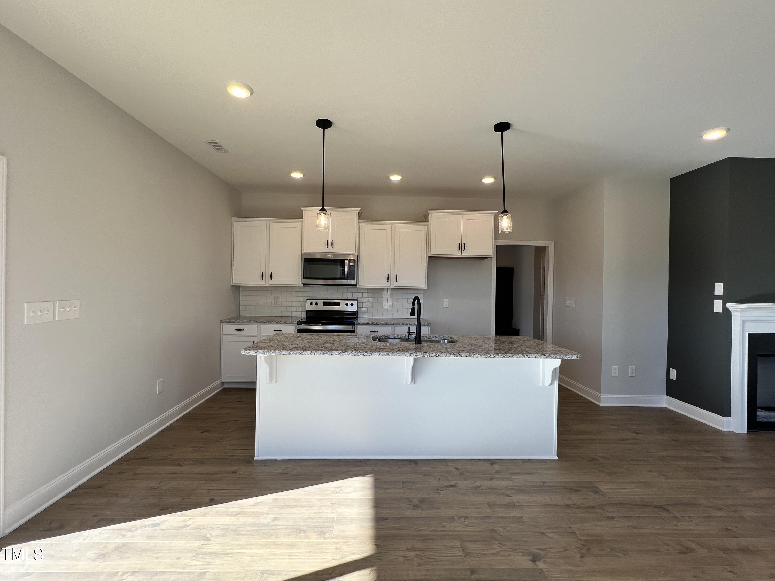 117 Isaac Lane Wendell, NC 27591 - Photo 2 of 16 a view of a kitchen with kitchen island stainless steel appliances a sink a refrigerator a stove a microwave and island