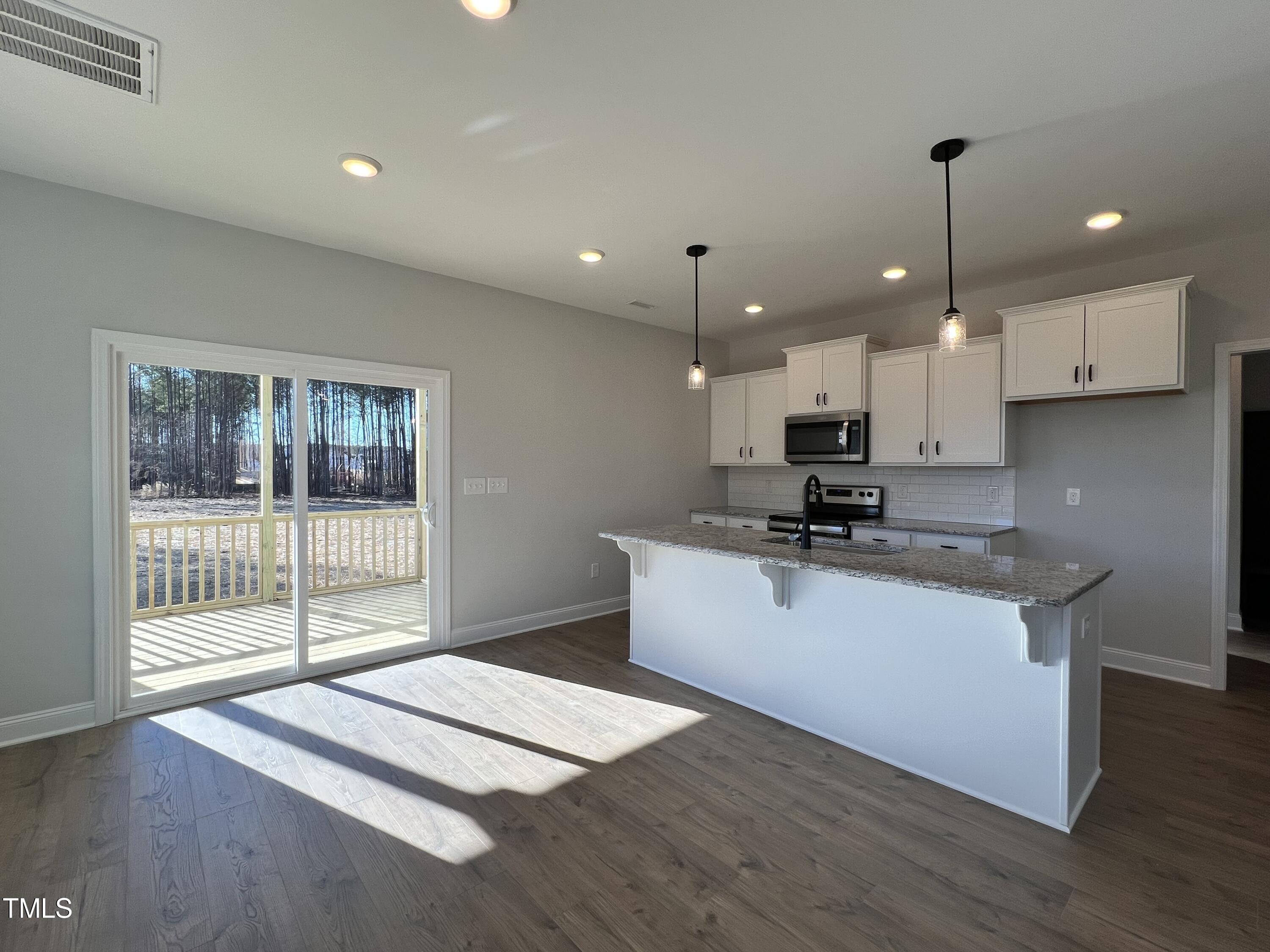 117 Isaac Lane Wendell, NC 27591 - Photo 3 of 16 a kitchen with kitchen island a counter top space a sink and appliances
