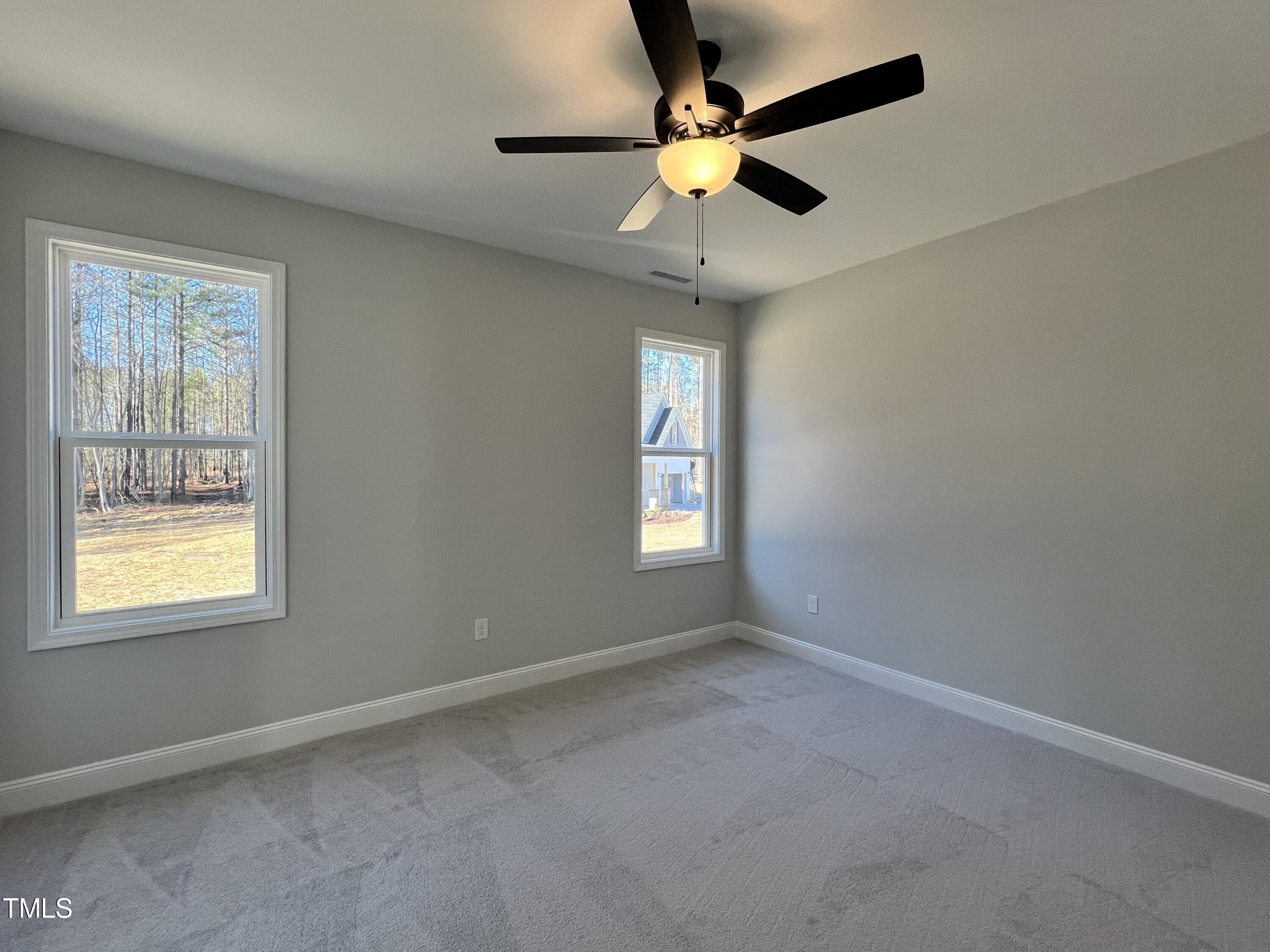 117 Isaac Lane Wendell, NC 27591 - Photo 8 of 16 an empty room with a window and a fan