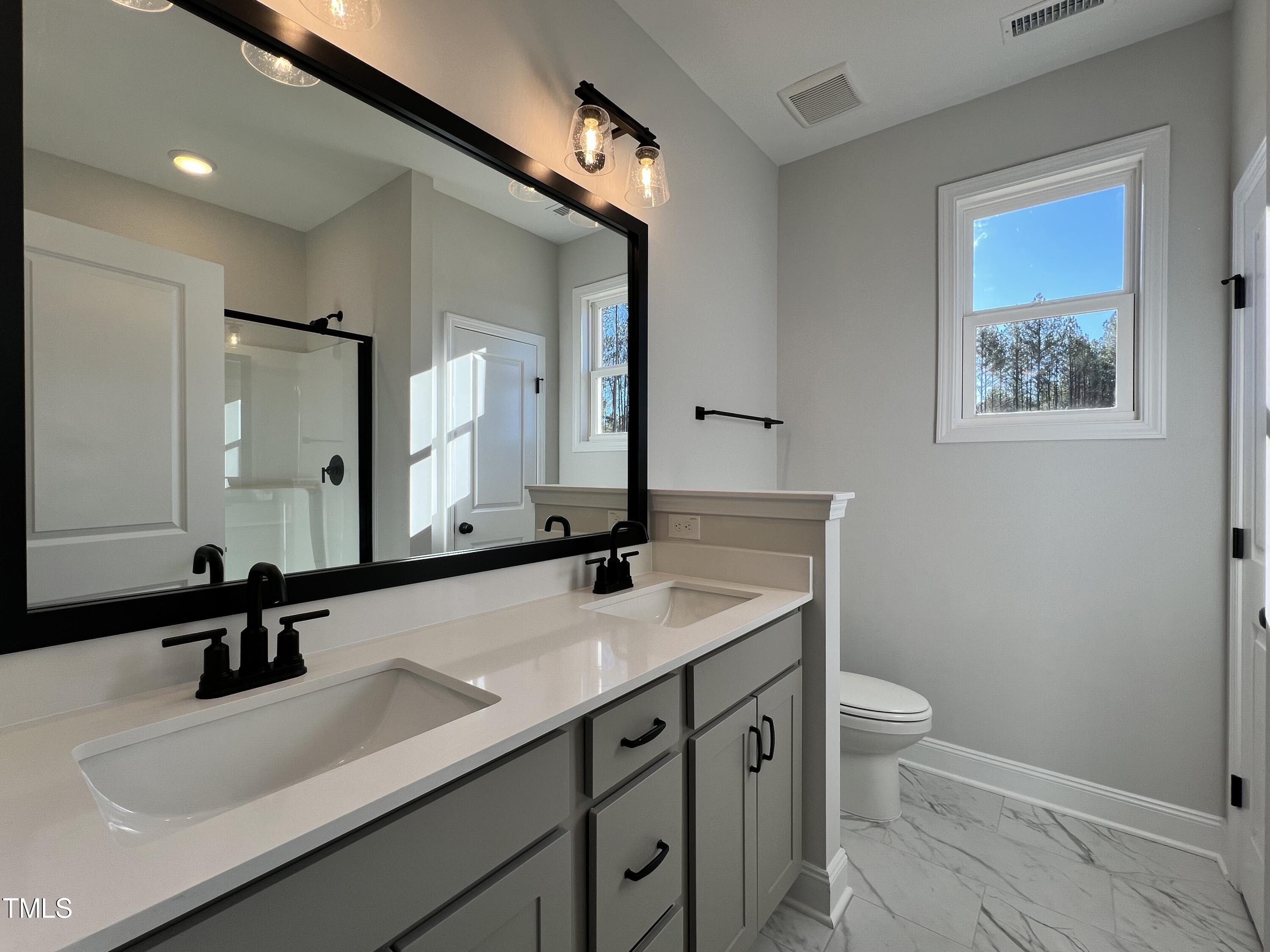 117 Isaac Lane Wendell, NC 27591 - Photo 9 of 16 a bathroom with a sink and a mirror