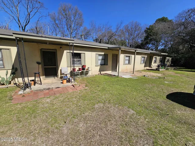 a view of a backyard with a car parked in it