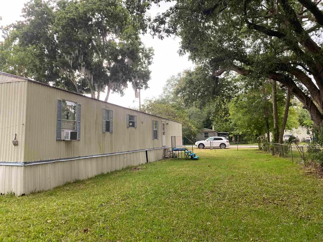 a view of a backyard with large trees