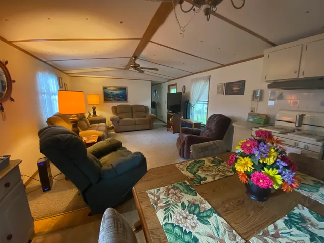 a living room with furniture chess board and flat screen tv