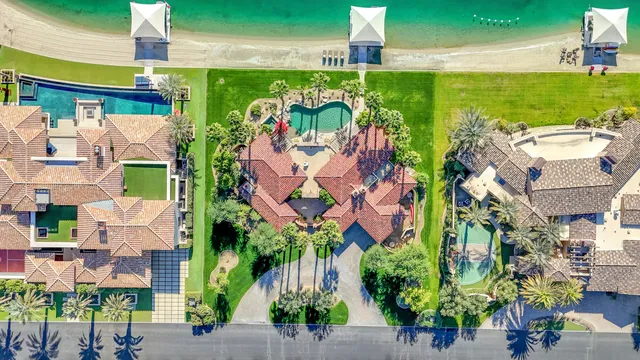a bathroom with a toilet sink vanity granite and shower