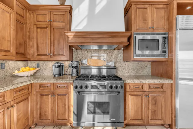 a utility room with a sink window and cabinets