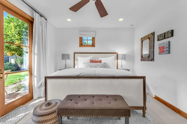 a bathroom with a granite countertop sink a toilet and a shower