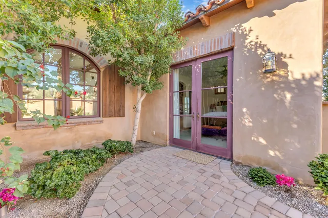 a bedroom with a large bed and a large window