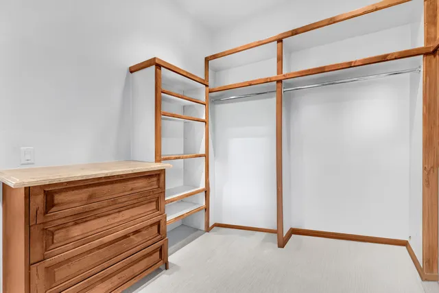 a outdoor view with a table and chairs under an umbrella