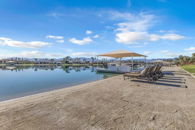 a view of residential houses with outdoor space and lake view