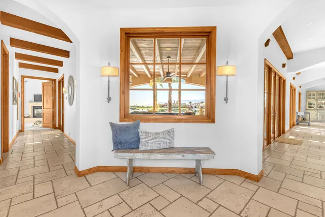 a living room with furniture a fireplace and a large window