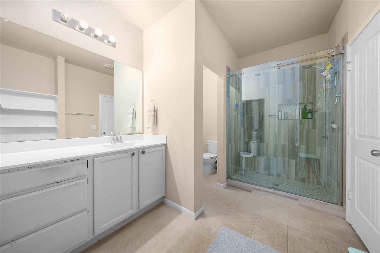 717 Kaluga Trail Leander, TX 78641 - Photo 17 of 40 a bathroom with a shower sink and mirror