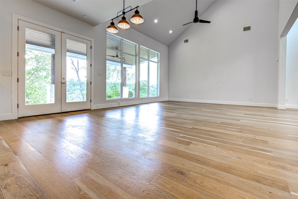 14210 Fort Smith Trail Austin, TX 78734 - Photo 13 of 37 a view of an empty room with wooden floor and a window