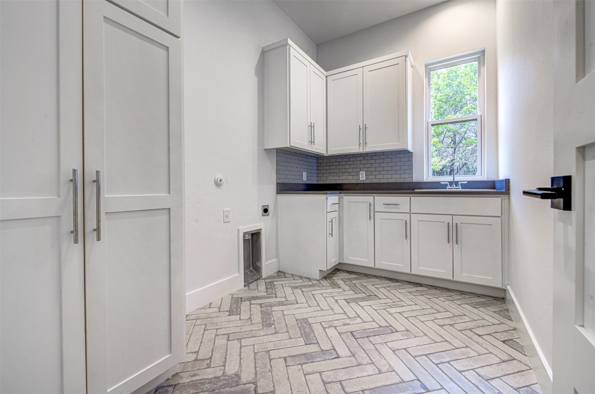14210 Fort Smith Trail Austin, TX 78734 - Photo 15 of 37 a kitchen with a stove a sink and a refrigerator