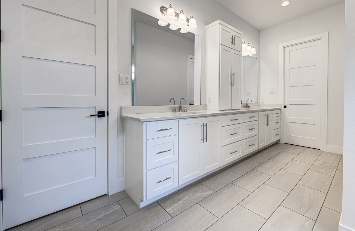 14210 Fort Smith Trail Austin, TX 78734 - Photo 19 of 37 a bathroom with a granite countertop sink a mirror and a