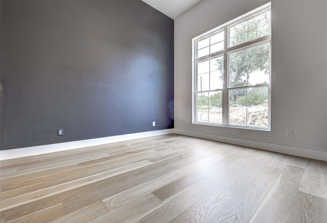 14210 Fort Smith Trail Austin, TX 78734 - Photo 24 of 37 an empty room with wooden floor and windows