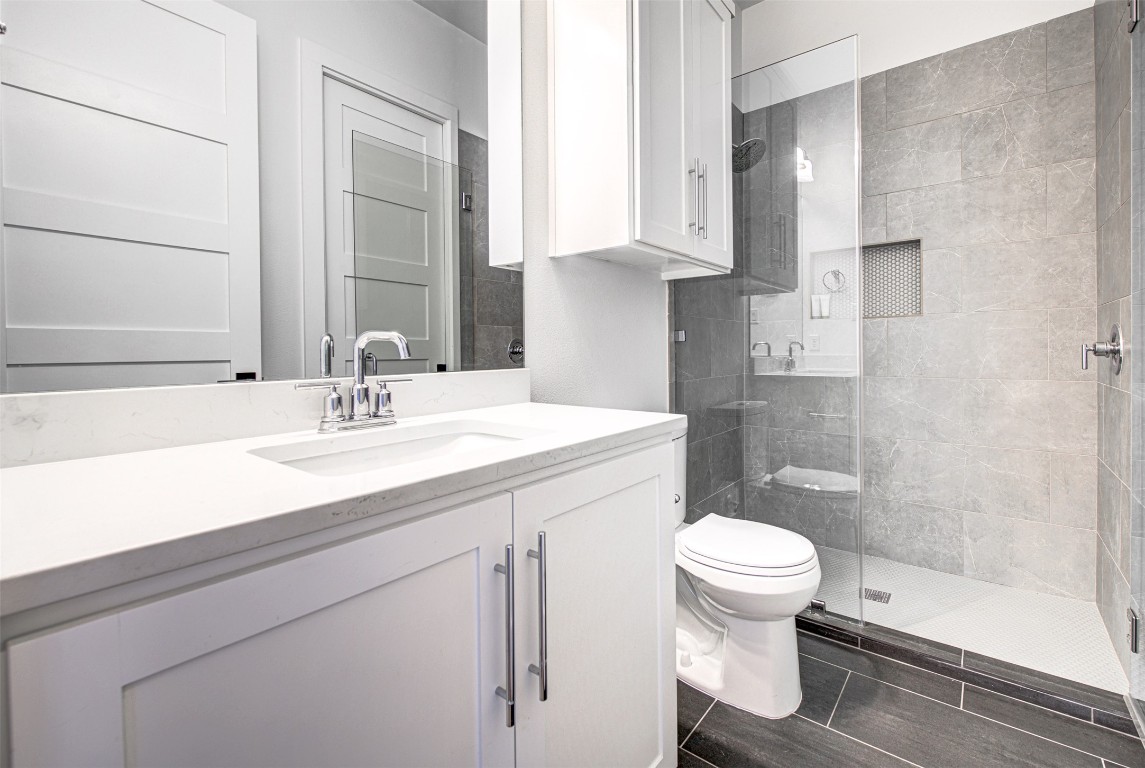 14210 Fort Smith Trail Austin, TX 78734 - Photo 25 of 37 a bathroom with a sink a toilet and shower