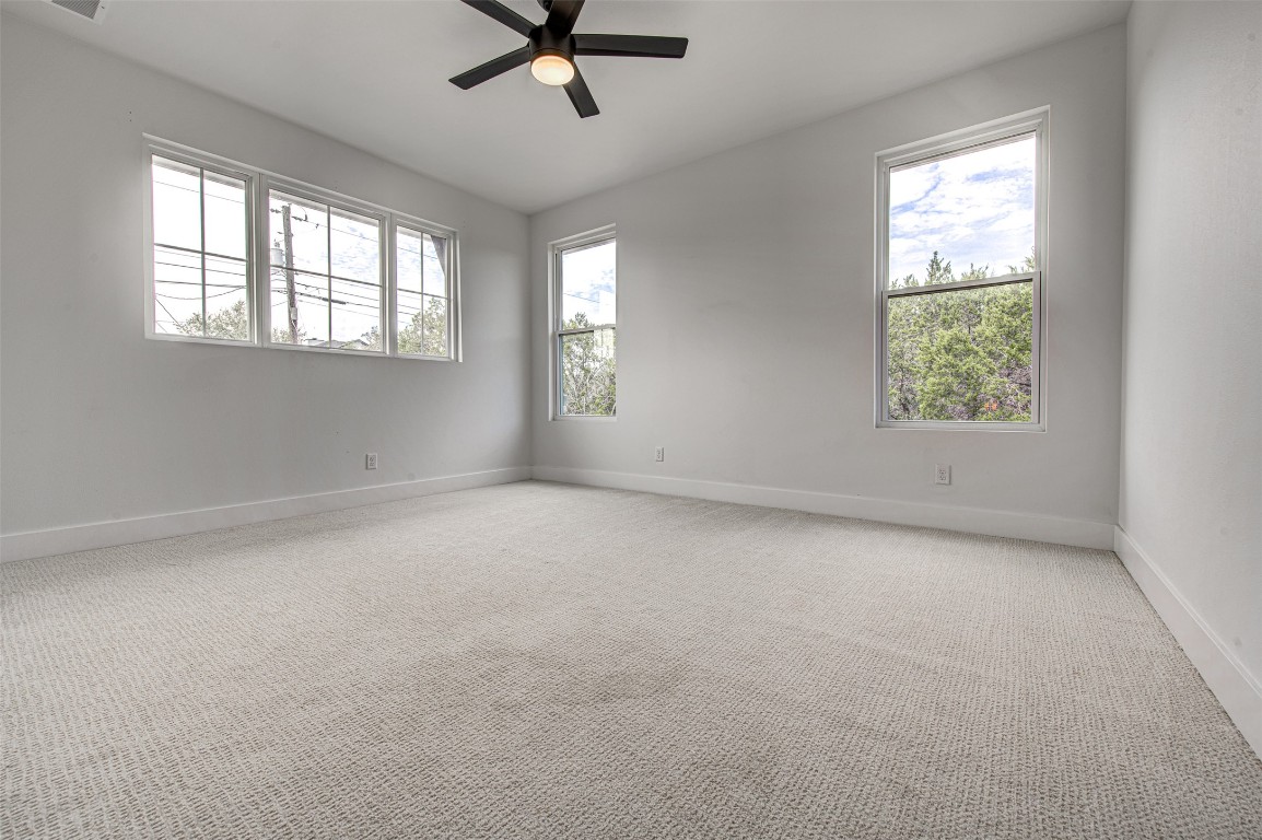 14210 Fort Smith Trail Austin, TX 78734 - Photo 26 of 37 an empty room with a window and a fan