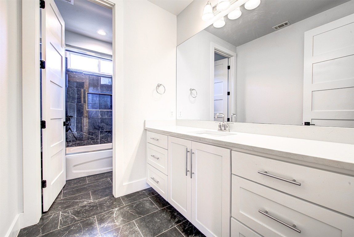 14210 Fort Smith Trail Austin, TX 78734 - Photo 29 of 37 a bathroom with a double vanity sink and a mirror