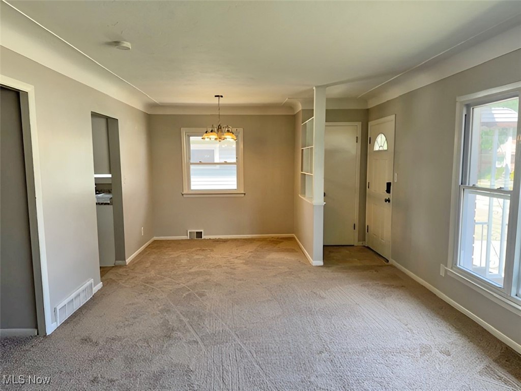 28642 Forest Road Willowick, OH 44095 - Photo 13 of 23 Unfurnished dining area with a chandelier and carpet floors