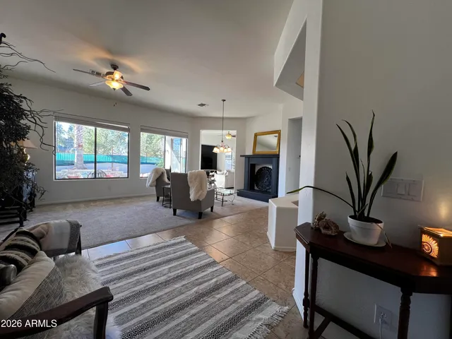 a living room with furniture potted plant and a window