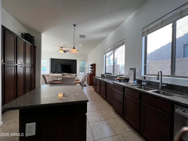 a large kitchen with a large counter top appliances and cabinets